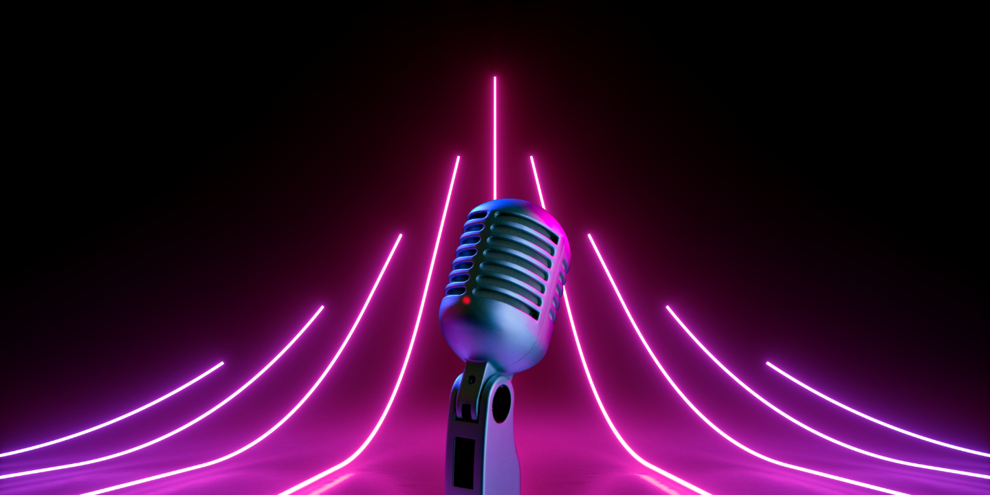 Silver vintage microphone centered against a black backdrop with radiating purple and pink neon lights