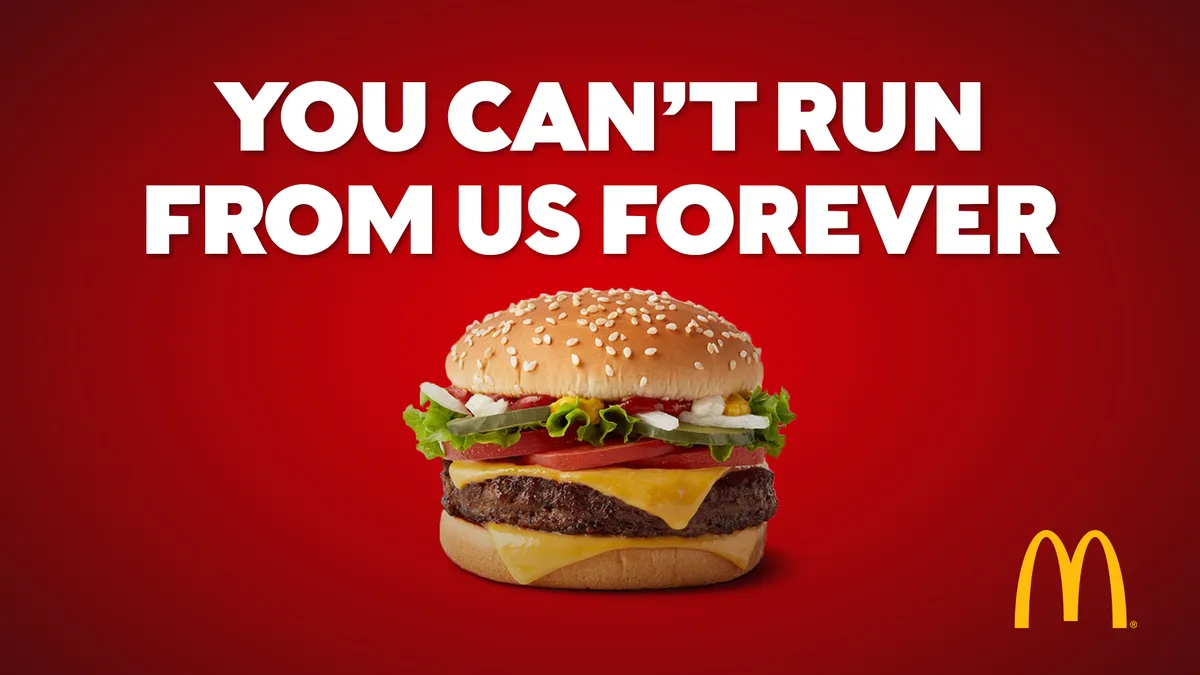 McDonald's ad with a large cheeseburger on a red background and the text "You can't run from us forever" above