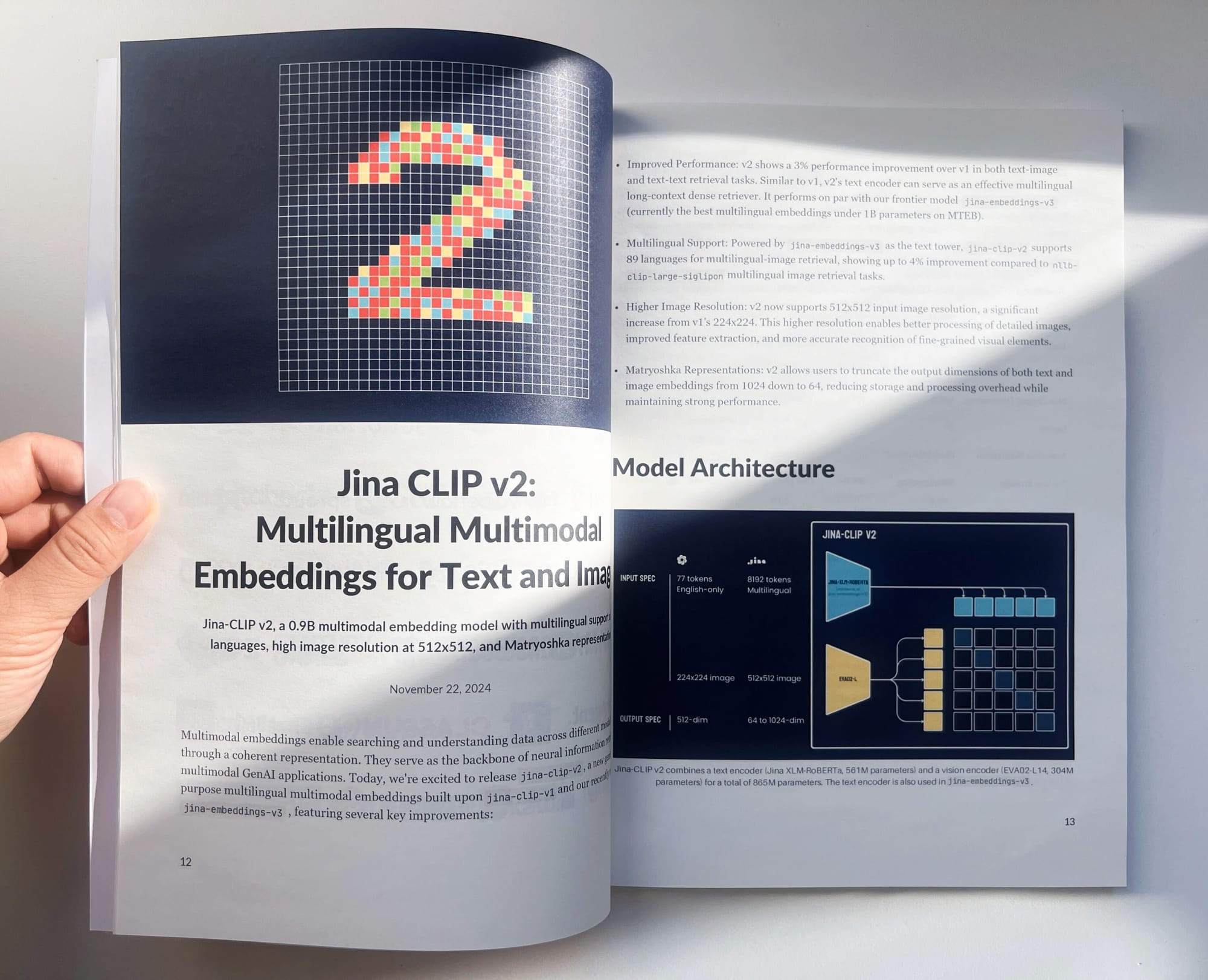 Open book on AI showcasing Jina CLIP v2, with diagrams and details on multilingual support, high-res image handling, and mode