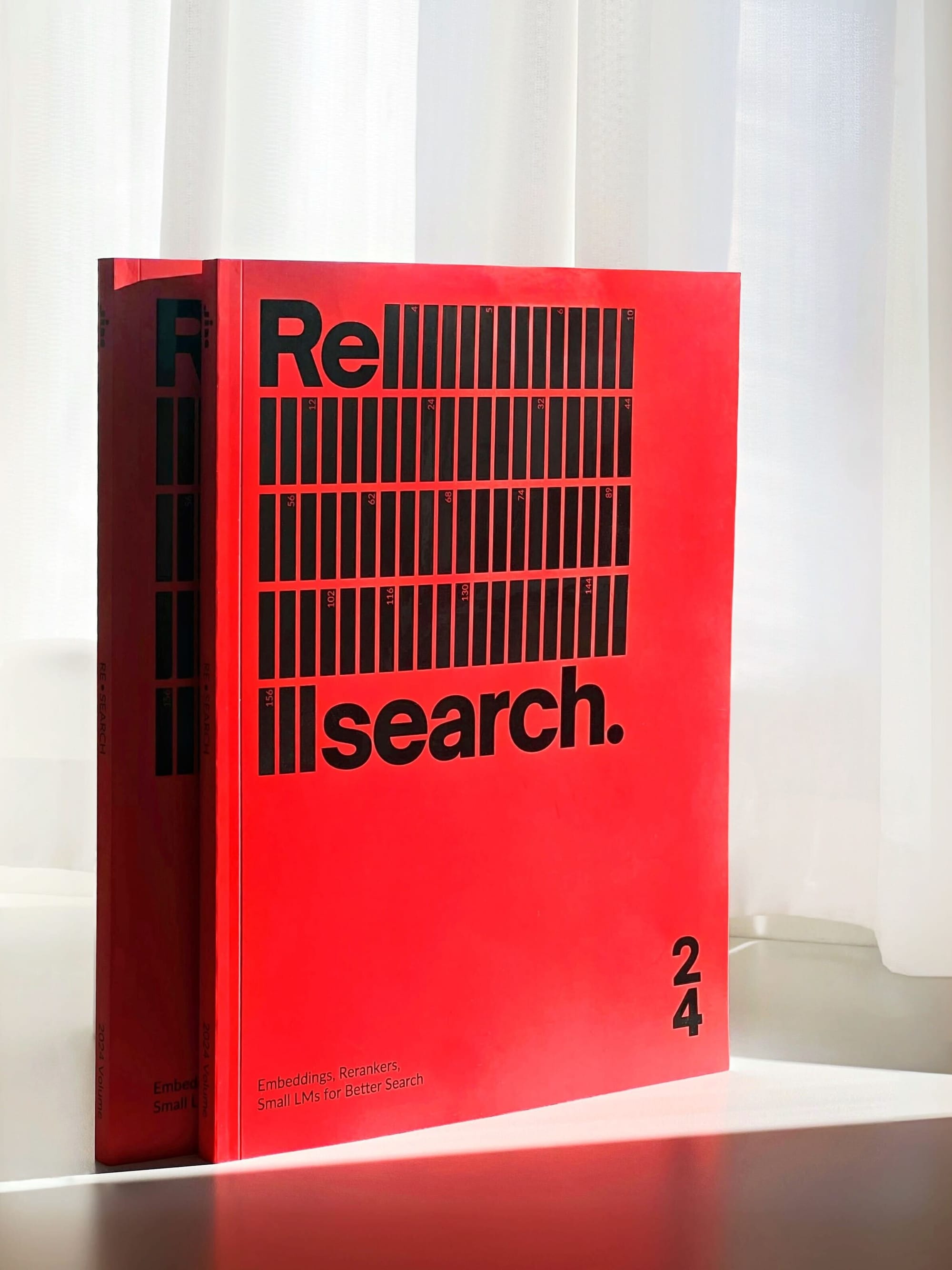 Red book titled "Re:Search 24" with abstract black design on a white background, featuring texts about search optimization.