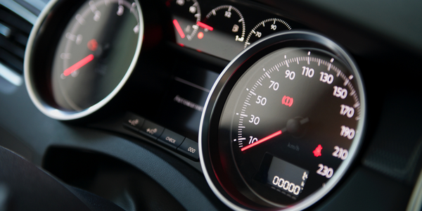 Car dashboard with a speedometer reading 0 km/h and additional displays for gear and fuel