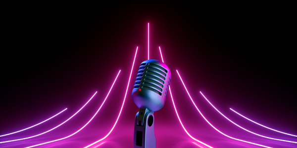 Silver vintage microphone centered against a black backdrop with radiating purple and pink neon lights